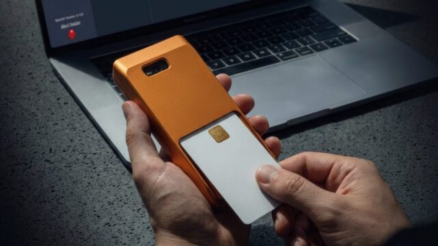 specter-shield-metal-orange-specter-desktop-qr-scan-hands-jpg