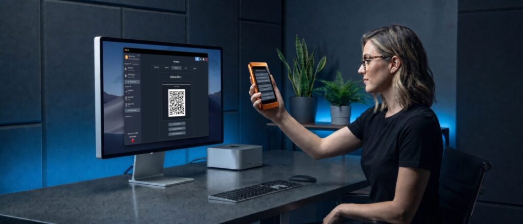 specter-shield-metal-orange-woman-desk-imac-specter-desktop-qr-scan-v3-jpg