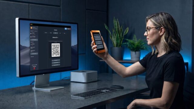 specter-shield-metal-orange-woman-desk-imac-specter-desktop-qr-scan-v3-jpg