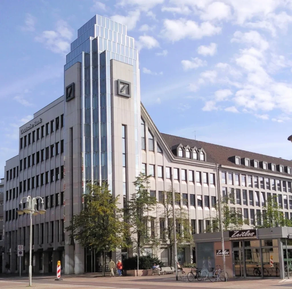 Modern bank building exterior in a German city representing Volksbank Raiffeisenbank Bayern, a regional cooperative bank
